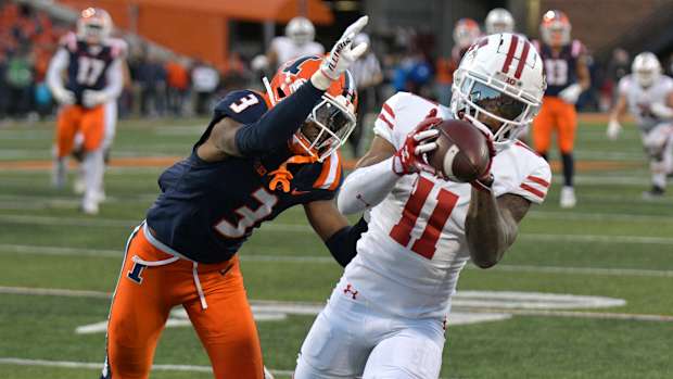 Oct 21, 2023; Champaign, Illinois, USA; Wisconsin Badgers wide receiver Skyler Bell (11) catches a pass in front of Illinois Fighting Illini defensive back Tahveon Nicholson (3) during the second half at Memorial Stadium. Mandatory Credit: Ron Johnson-USA TODAY Sports